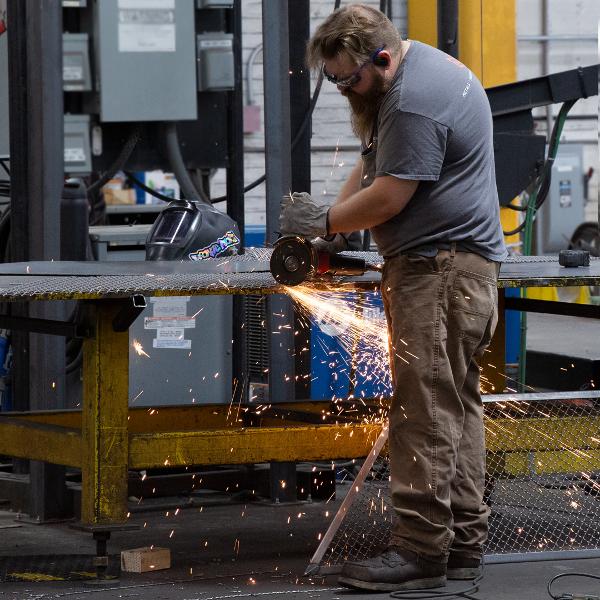 https://www.coremarkmetals.com/files/image/medium/Fabricator grinding wire mesh sparks flying