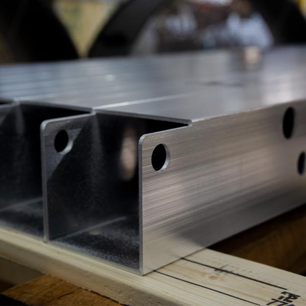 https://www.coremarkmetals.com/files/image/medium/Aluminum square tubing with hole cutouts