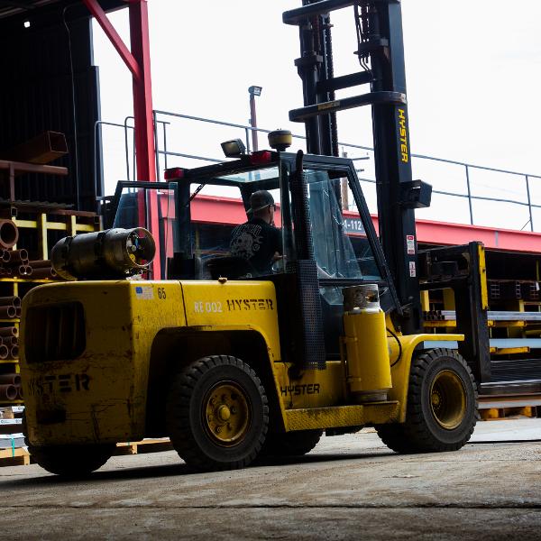 https://www.coremarkmetals.com/files/image/medium/Driver operating yellow forklift in steel yard