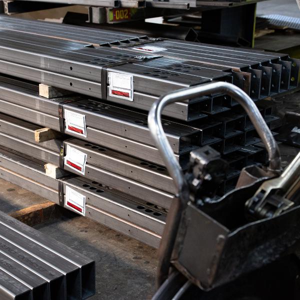 https://www.coremarkmetals.com/files/image/medium/laser cut steel tubing banded in warehouse